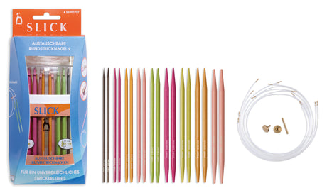 Slick knitting needle set shown with its retail box, a row of multicolored round knitting needles, and a coiled white cable with two brass tips on a plain white background.